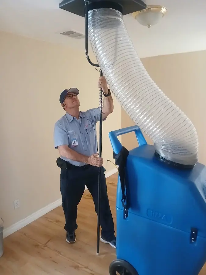 Furnace Tune-Up technician using HEPA equipment in Leavenworth